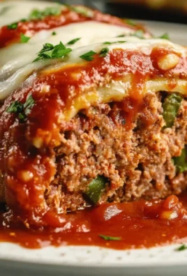 Stuffed Italian meatloaf garnished with herbs and served with marinara sauce
