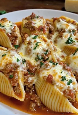 Plate of stuffed pasta shells filled with cheese and herbs in marinara sauce