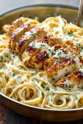 Delicious creamy garlic parmesan chicken pasta garnished with herbs