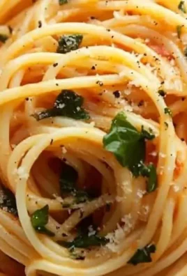 Delicious plate of Tomato Butter Pasta topped with herbs and grated cheese.