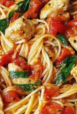 Plate of Tomato Spinach Chicken Spaghetti garnished with fresh herbs