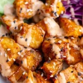 Crispy Bang Bang Tofu served with a spicy sauce on a plate