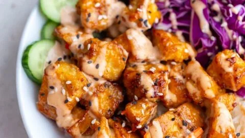 Crispy Bang Bang Tofu served with a spicy sauce on a plate