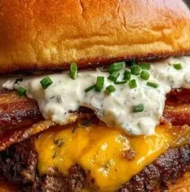 Loaded ranch bacon burger with cheese and toppings on a plate