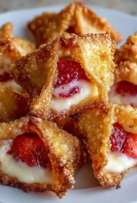 Deep-fried strawberry cheesecake bites stuffed in wonton wrappers