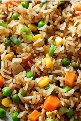 Bowl of easy fried rice with vegetables and eggs, garnished with green onions
