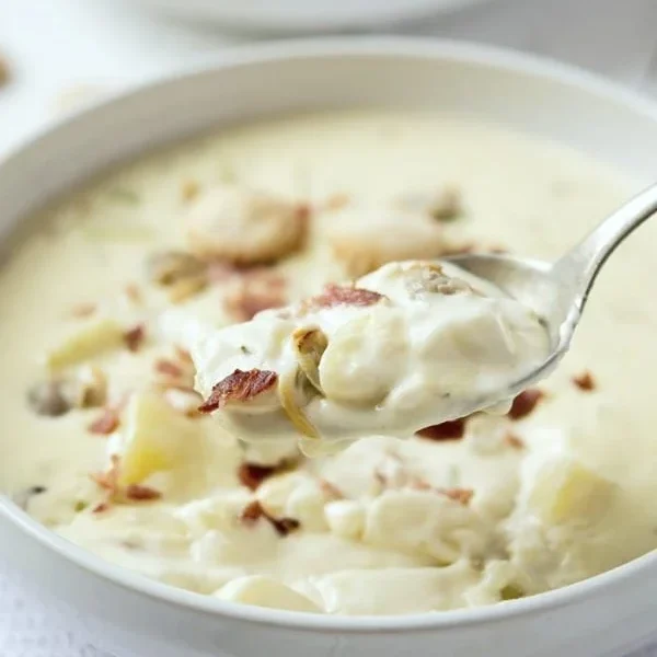 Bowl of five-star New England clam chowder garnished with parsley.