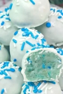 Colorful frozen cake pops arranged on a platter for a festive dessert display.