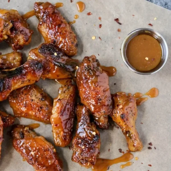 Hot honey mustard wings served on a platter with dipping sauce