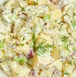 A bowl of Ina Garten's creamy potato salad with herbs and spices