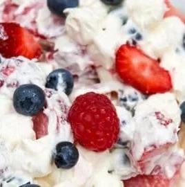 Red White and Blue Cheesecake Salad with berries and creamy cheesecake layers.