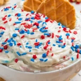 Delicious Red, White and Blue Funfetti Dip served in a festive bowl.