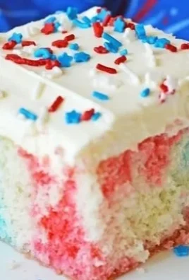 Red White and Blue Poke Cake topped with strawberries and blueberries