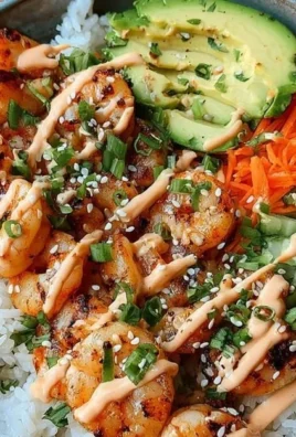 Shrimp rice bowl topped with spicy mayo and fresh vegetables