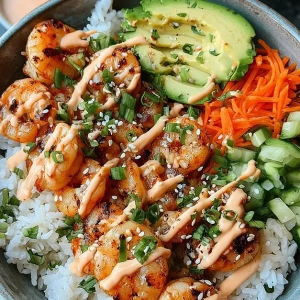 Shrimp rice bowl topped with spicy mayo and fresh vegetables