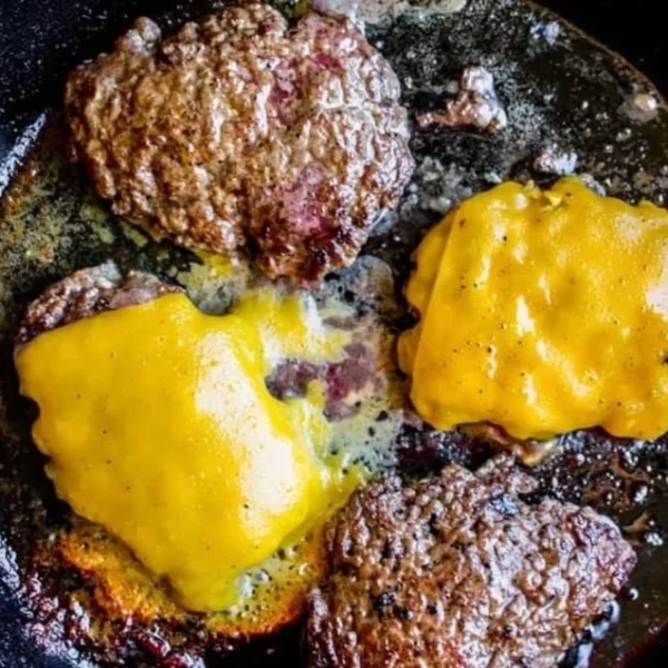 Delicious homemade smash burger with toppings on a wooden table