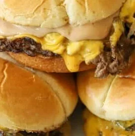 Juicy smash burgers with melted cheese and fresh toppings on a bun