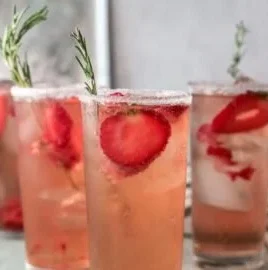 A refreshing Strawberry Paloma cocktail garnished with fresh strawberries and lime.