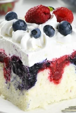 Delicious Summer Berry Poke Cake topped with fresh berries and whipped cream.