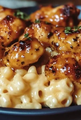 Delicious honey pepper chicken served with creamy macaroni cheese on a plate