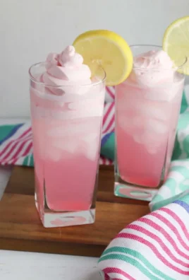 Refreshing whipped pink lemonade with vibrant color and creamy texture.