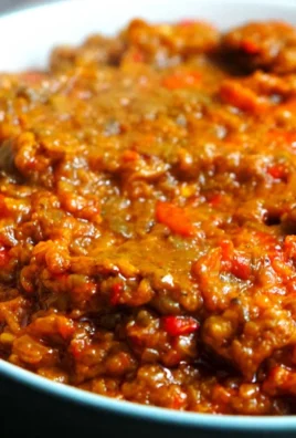 Jar of homemade zacusca, a savory vegetable spread made from roasted peppers and eggplants