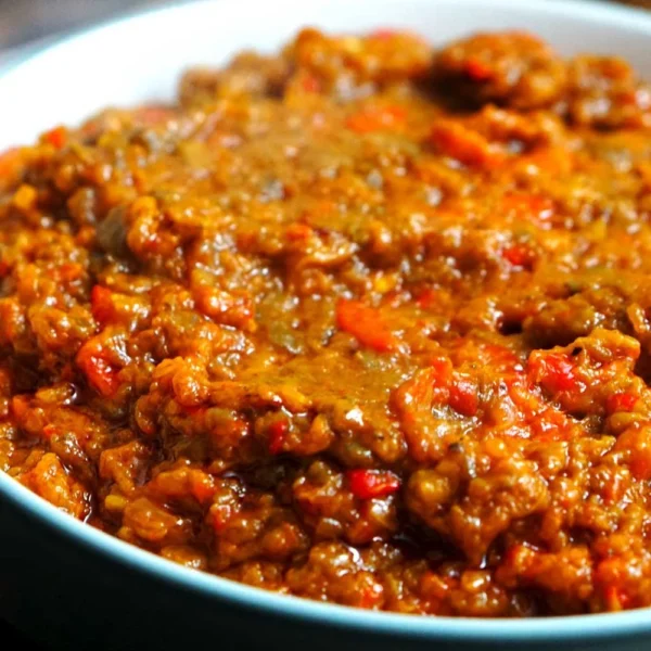 Jar of homemade zacusca, a savory vegetable spread made from roasted peppers and eggplants
