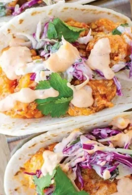 Delicious Bang Bang Shrimp Tacos served with fresh toppings and sauce