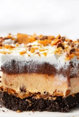 Delicious Butterfinger Lush dessert with chocolate and peanut butter layers