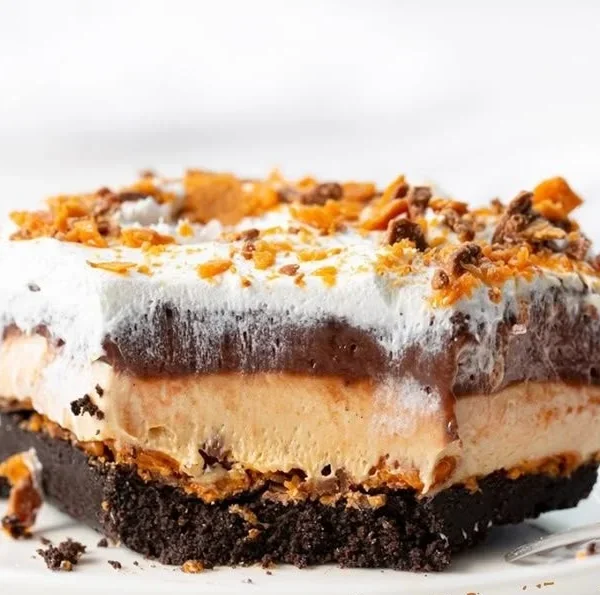 Delicious Butterfinger Lush dessert with chocolate and peanut butter layers