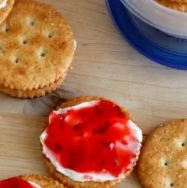 Plate of cream cheese and jam cracker snacks ready to be enjoyed