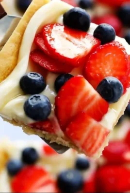 Delicious easy fruit pizza topped with fresh fruits and creamy frosting