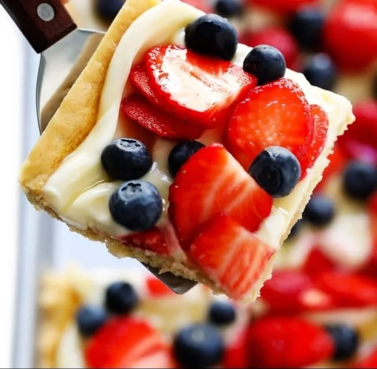 Delicious easy fruit pizza topped with fresh fruits and creamy frosting