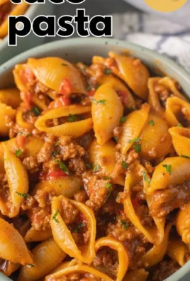 High protein taco pasta dish garnished with herbs and ready to serve.