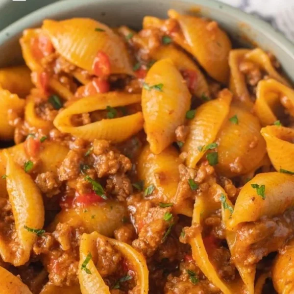 High protein taco pasta dish garnished with herbs and ready to serve.