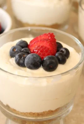 Individual no-bake cheesecake cups dessert in a clear cup