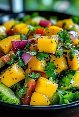 Delicious mango salad topped with lime dressing and fresh ingredients