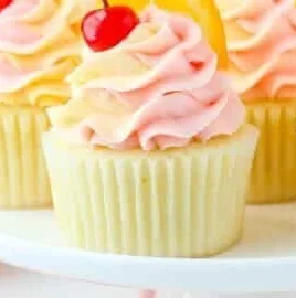 Tequila Sunrise Cupcakes with vibrant colors and garnished with citrus.