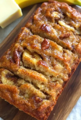 Delicious slice of homemade banana bread on a wooden cutting board